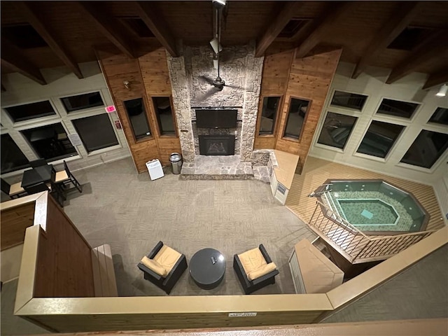 B45A Stoneridge Dr, Seven Springs Resort, PA 15557 - living area featuring beamed ceiling, an outdoor stone fireplace, and wooden walls