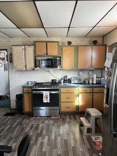 6 Pine St, Natrona Hts/Harrison Twp, PA 15065 - kitchen featuring stainless steel appliances, a paneled ceiling, dark wood-style floors, and dark countertops