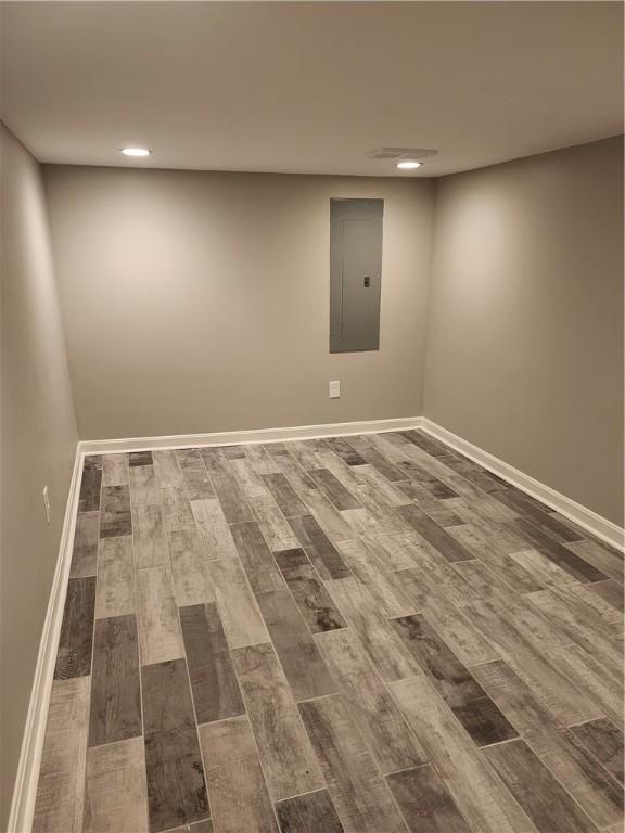 165 45th St, Lawrenceville, PA 15201 - finished basement with electric panel, dark wood-style flooring, recessed lighting, and baseboards