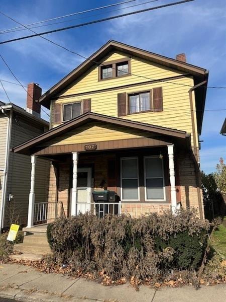 107 E 1st Ave, Tarentum, PA 15084 - view of front of home featuring covered porch and a chimney