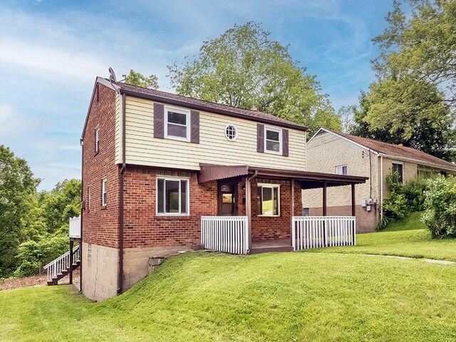 129 Martinique Dr, Penn Hills, PA 15235 - back of property featuring a porch, a lawn, brick siding, and stairway
