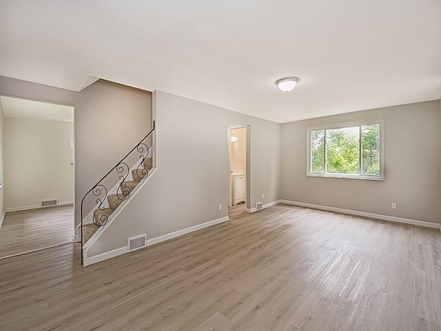 129 Martinique Dr, Penn Hills, PA 15235 - empty room featuring wood finished floors, stairway, and baseboards