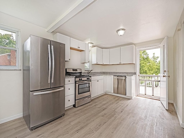 129 Martinique Dr, Penn Hills, PA 15235 - kitchen with stainless steel appliances, white cabinetry, light wood-type flooring, and healthy amount of natural light