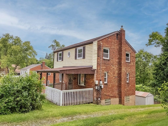 129 Martinique Dr, Penn Hills, PA 15235 - back of property featuring a chimney, brick siding, a yard, and a porch