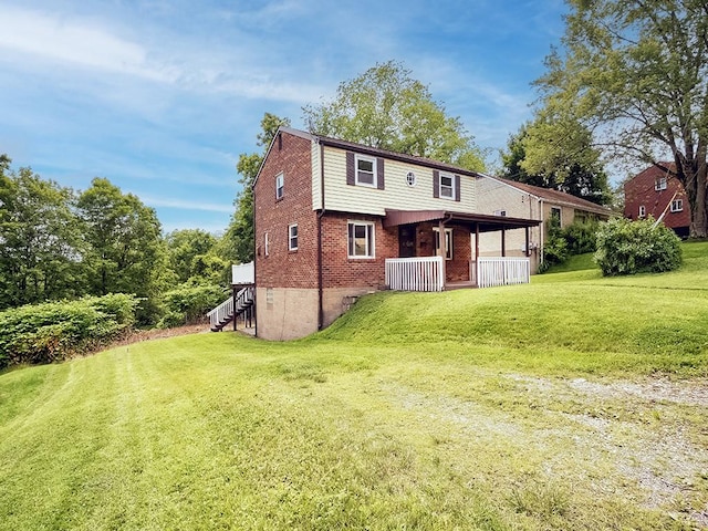 129 Martinique Dr, Penn Hills, PA 15235 - back of property featuring brick siding, a yard, covered porch, and stairway
