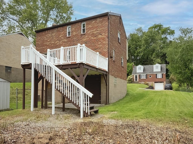 129 Martinique Dr, Penn Hills, PA 15235 - rear view of house featuring brick siding, a deck, a lawn, stairway, and a garage