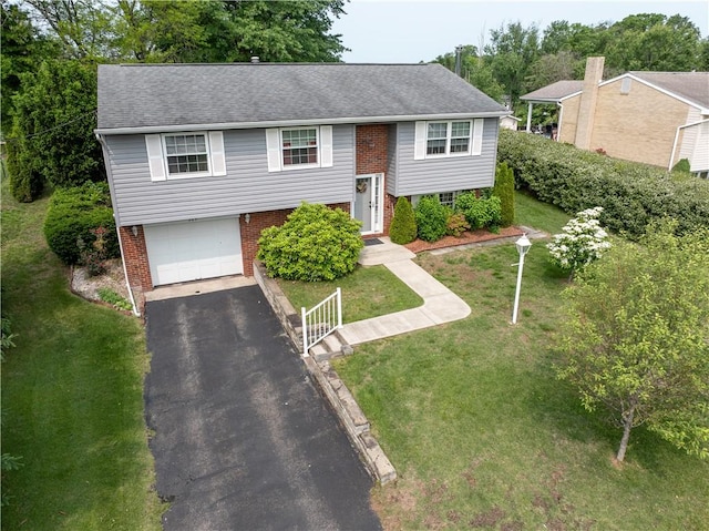 205 Van Dr, Bullskin Twp, PA 15425 - split foyer home with an attached garage, driveway, a front lawn, roof with shingles, and brick siding