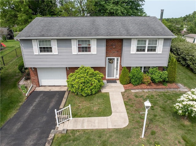 205 Van Dr, Bullskin Twp, PA 15425 - bi-level home with brick siding, a garage, asphalt driveway, and a shingled roof