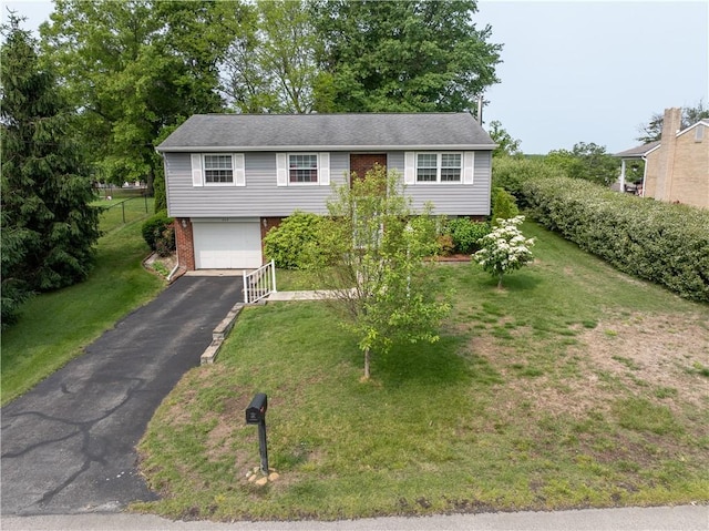 205 Van Dr, Bullskin Twp, PA 15425 - raised ranch with driveway, an attached garage, a front yard, and brick siding
