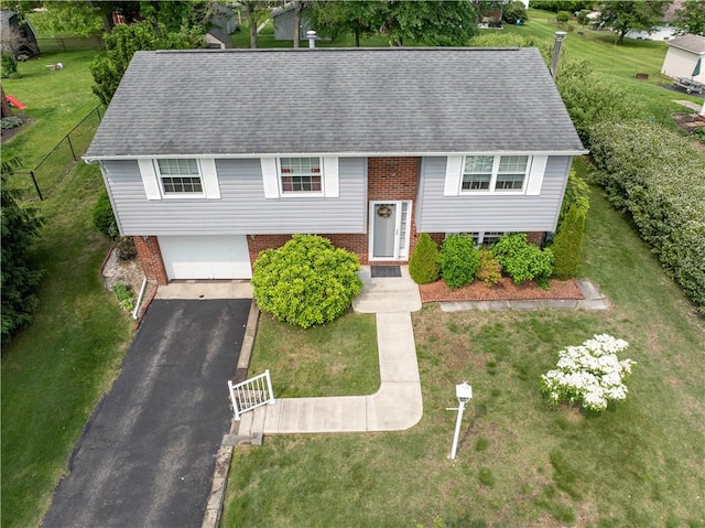 205 Van Dr, Bullskin Twp, PA 15425 - bi-level home with brick siding, asphalt driveway, an attached garage, a front yard, and a shingled roof
