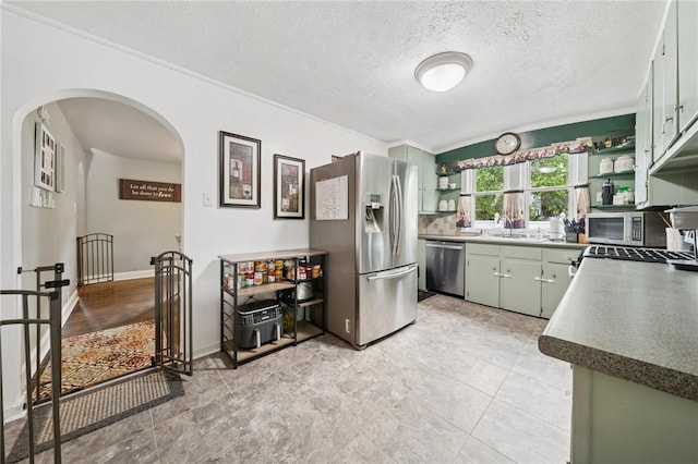 2510 7th St, New Kensington, PA 15068 - kitchen with appliances with stainless steel finishes, open shelves, arched walkways, crown molding, and a textured ceiling