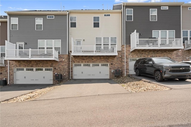 150 Moyer Hill Dr, Cranberry Twp, PA 16066 - back of property with asphalt driveway, a garage, and central AC