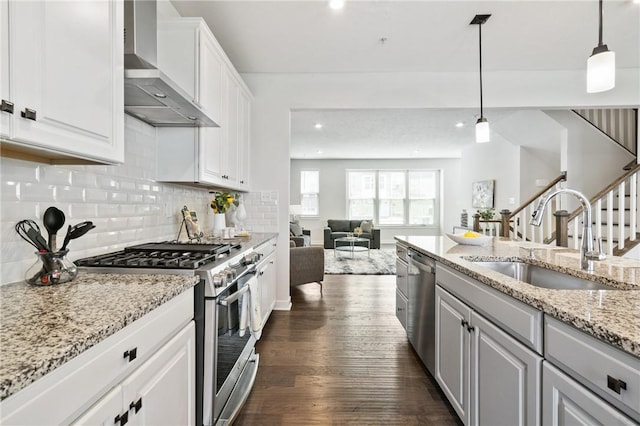 150 Moyer Hill Dr, Cranberry Twp, PA 16066 - kitchen with appliances with stainless steel finishes, wall chimney exhaust hood, a sink, open floor plan, and dark wood finished floors