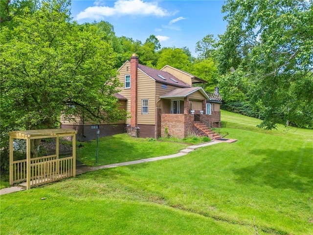 600 Pineview Dr Unit 590, Elizabeth Twp/Boro, PA 15037 - view of property exterior with a chimney, a yard, and brick siding