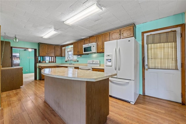 600 Pineview Dr Unit 590, Elizabeth Twp/Boro, PA 15037 - kitchen with white appliances, light countertops, light wood finished floors, a kitchen island, and healthy amount of natural light