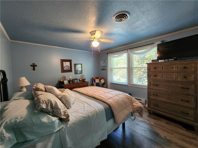 911 Aztec Trl, Coolspring Twp, PA 16137 - bedroom with ornamental molding, dark wood-style floors, a textured ceiling, ceiling fan, and baseboard heating