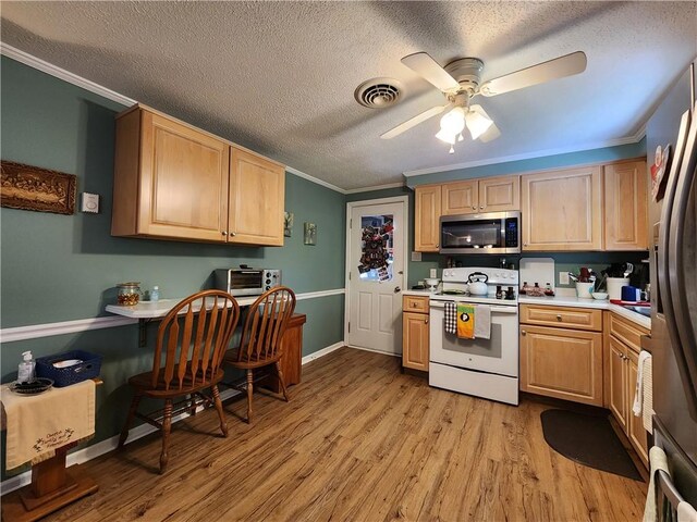 911 Aztec Trl, Coolspring Twp, PA 16137 - kitchen featuring appliances with stainless steel finishes, ornamental molding, ceiling fan, light wood-style floors, and light countertops