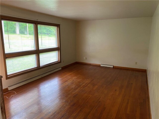 327 Craig St, Manor Twp, PA 16226 - unfurnished room with a baseboard heating unit, wood finished floors, and baseboards