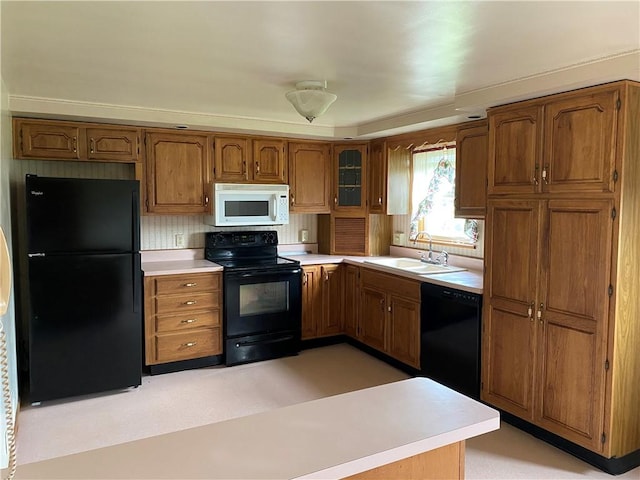 327 Craig St, Manor Twp, PA 16226 - kitchen featuring black appliances, a sink, brown cabinets, and light countertops