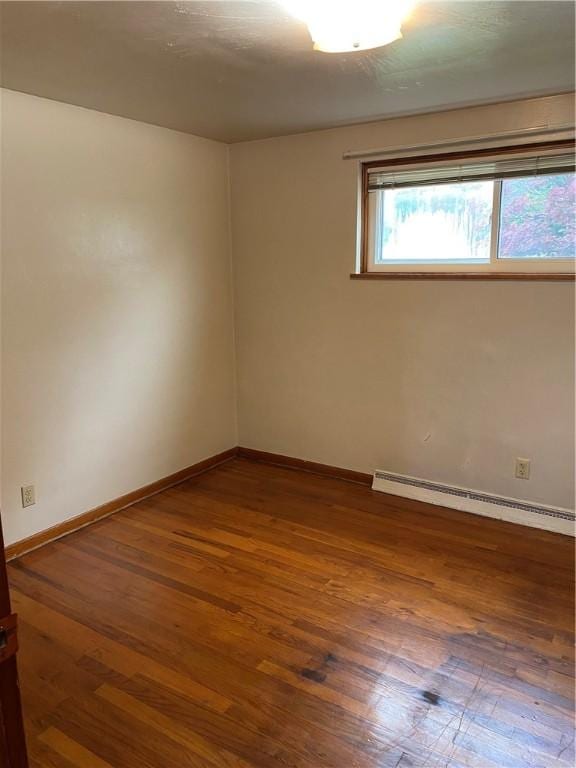 327 Craig St, Manor Twp, PA 16226 - empty room with a baseboard heating unit, wood finished floors, and baseboards