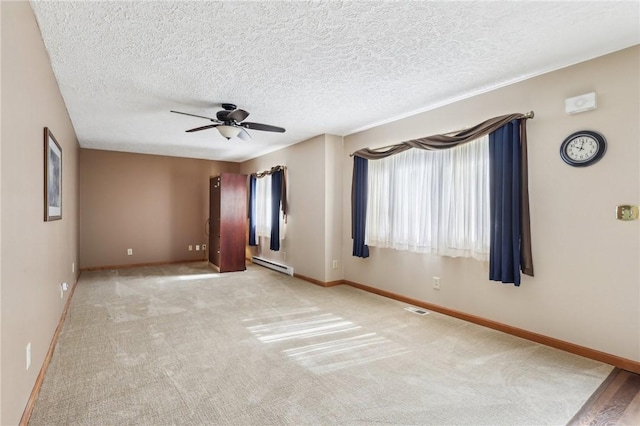 96 Concord Rd, Hermitage, PA 16148 - spare room featuring a baseboard heating unit, ceiling fan, baseboards, carpet, and a textured ceiling