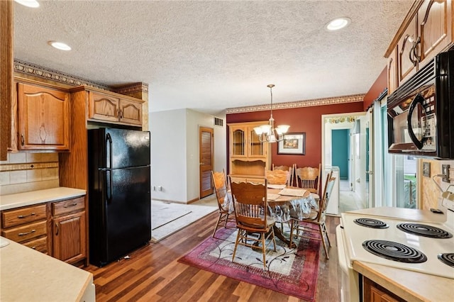 96 Concord Rd, Hermitage, PA 16148 - kitchen featuring black appliances, light countertops, a chandelier, dark wood-type flooring, and brown cabinetry