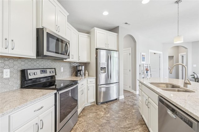 219 Brookside Dr, Cranberry Twp, PA 16066 - kitchen featuring appliances with stainless steel finishes, a sink, arched walkways, white cabinets, and recessed lighting