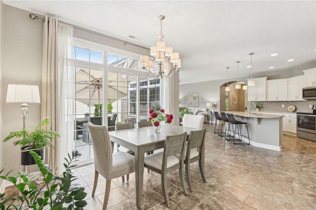 219 Brookside Dr, Cranberry Twp, PA 16066 - dining area featuring a chandelier, recessed lighting, and arched walkways