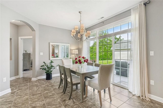 219 Brookside Dr, Cranberry Twp, PA 16066 - dining space featuring a chandelier, arched walkways, and baseboards