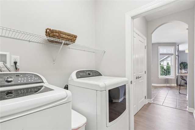 219 Brookside Dr, Cranberry Twp, PA 16066 - laundry area with washer and dryer, arched walkways, wood finished floors, and baseboards