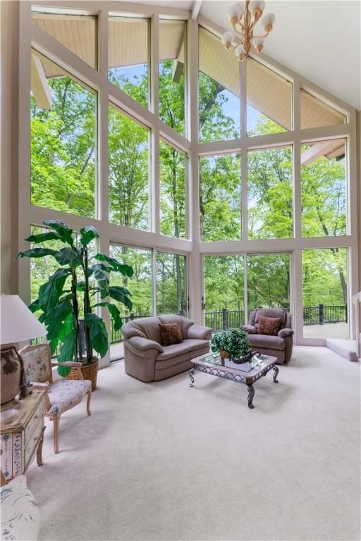 504 Timber Ln, Jefferson Hills, PA 15025 - living area with high vaulted ceiling, carpet floors, and a chandelier