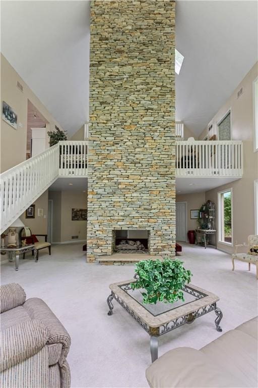 504 Timber Ln, Jefferson Hills, PA 15025 - carpeted living area with high vaulted ceiling, a stone fireplace, and stairs
