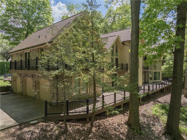504 Timber Ln, Jefferson Hills, PA 15025 - view of side of property with stone siding, a shingled roof, a deck, and a garage