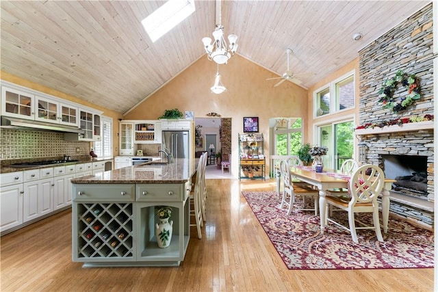 504 Timber Ln, Jefferson Hills, PA 15025 - kitchen with stainless steel refrigerator, high vaulted ceiling, a sink, black stovetop, and under cabinet range hood