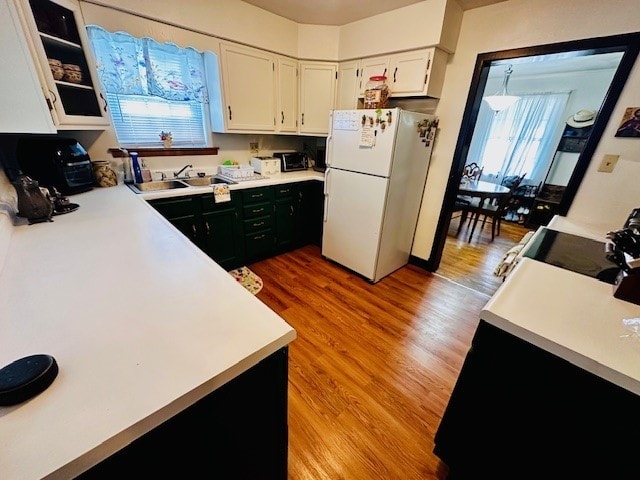 378 Ceylon Rd, Carmichaels/Cumblnd, PA 15320 - kitchen featuring freestanding refrigerator, light wood-style flooring, stainless steel electric range oven, white cabinets, and light countertops