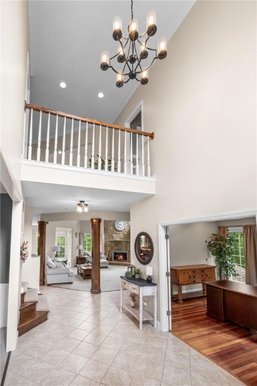 110 Marcur Ln, Center Twp Bea, PA 15061 - tiled foyer featuring a high ceiling, a chandelier, a fireplace, and recessed lighting