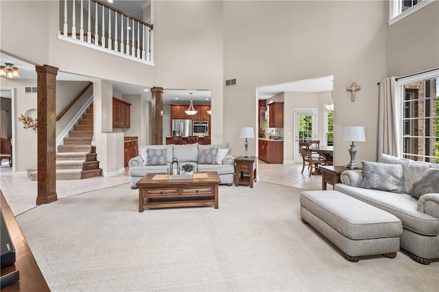 110 Marcur Ln, Center Twp Bea, PA 15061 - living room with ornate columns, light tile patterned flooring, a high ceiling, stairs, and baseboards