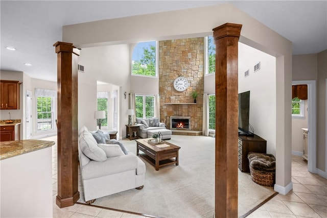 110 Marcur Ln, Center Twp Bea, PA 15061 - living room with healthy amount of natural light, light tile patterned flooring, ornate columns, a stone fireplace, and recessed lighting