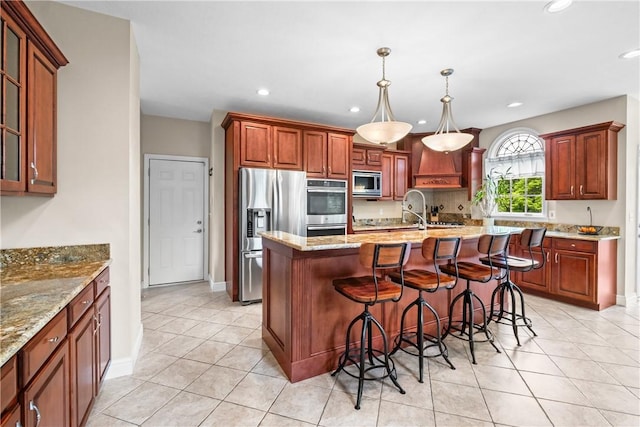 110 Marcur Ln, Center Twp Bea, PA 15061 - kitchen featuring appliances with stainless steel finishes, light tile patterned flooring, a kitchen breakfast bar, light stone countertops, and a center island with sink