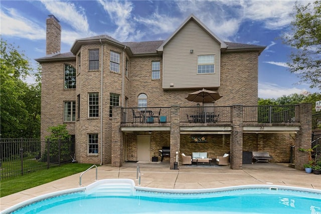 110 Marcur Ln, Center Twp Bea, PA 15061 - rear view of property featuring a patio, a chimney, a balcony, and brick siding