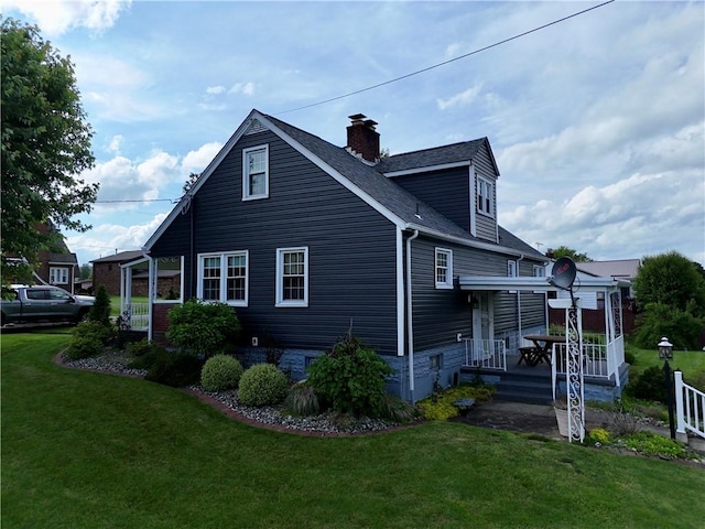 411 Harrison W, Kittanning Boro, PA 16201 - view of property exterior featuring a yard, a chimney, and roof with shingles