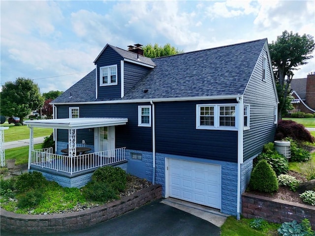 411 Harrison W, Kittanning Boro, PA 16201 - view of front facade featuring a porch, a garage, a shingled roof, driveway, and a chimney