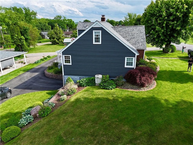 411 Harrison W, Kittanning Boro, PA 16201 - view of property exterior featuring a chimney, a shingled roof, and a lawn