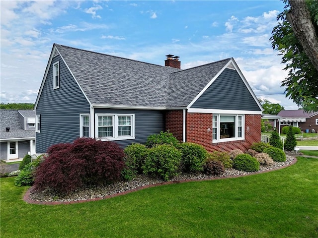 411 Harrison W, Kittanning Boro, PA 16201 - view of side of home with roof with shingles, a lawn, a chimney, and brick siding