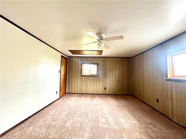 301 4th St, Luzerne Twp, PA 15413 - empty room with light carpet, a ceiling fan, baseboards, wood walls, and ornamental molding