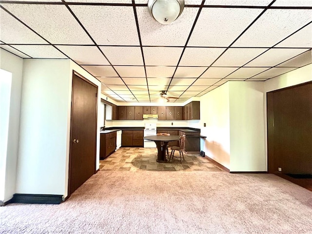 301 4th St, Luzerne Twp, PA 15413 - kitchen with light colored carpet, under cabinet range hood, a paneled ceiling, white appliances, and baseboards