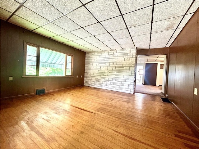 301 4th St, Luzerne Twp, PA 15413 - empty room featuring wood finished floors, a paneled ceiling, and wooden walls