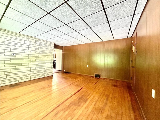 301 4th St, Luzerne Twp, PA 15413 - unfurnished living room with wood finished floors and wooden walls