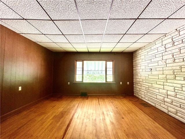 301 4th St, Luzerne Twp, PA 15413 - unfurnished room featuring wood-type flooring, a paneled ceiling, and wooden walls