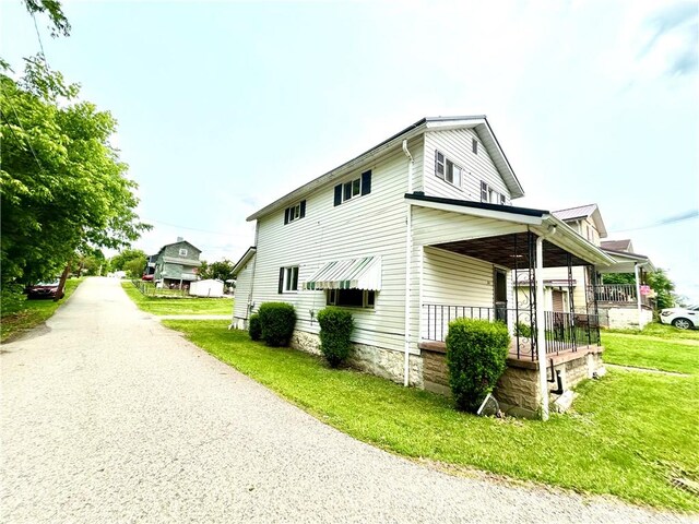 301 4th St, Luzerne Twp, PA 15413 - view of property exterior with a porch and a yard